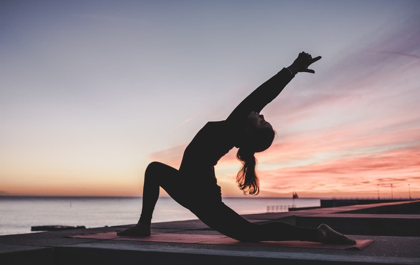 Person stretching on a mat after training